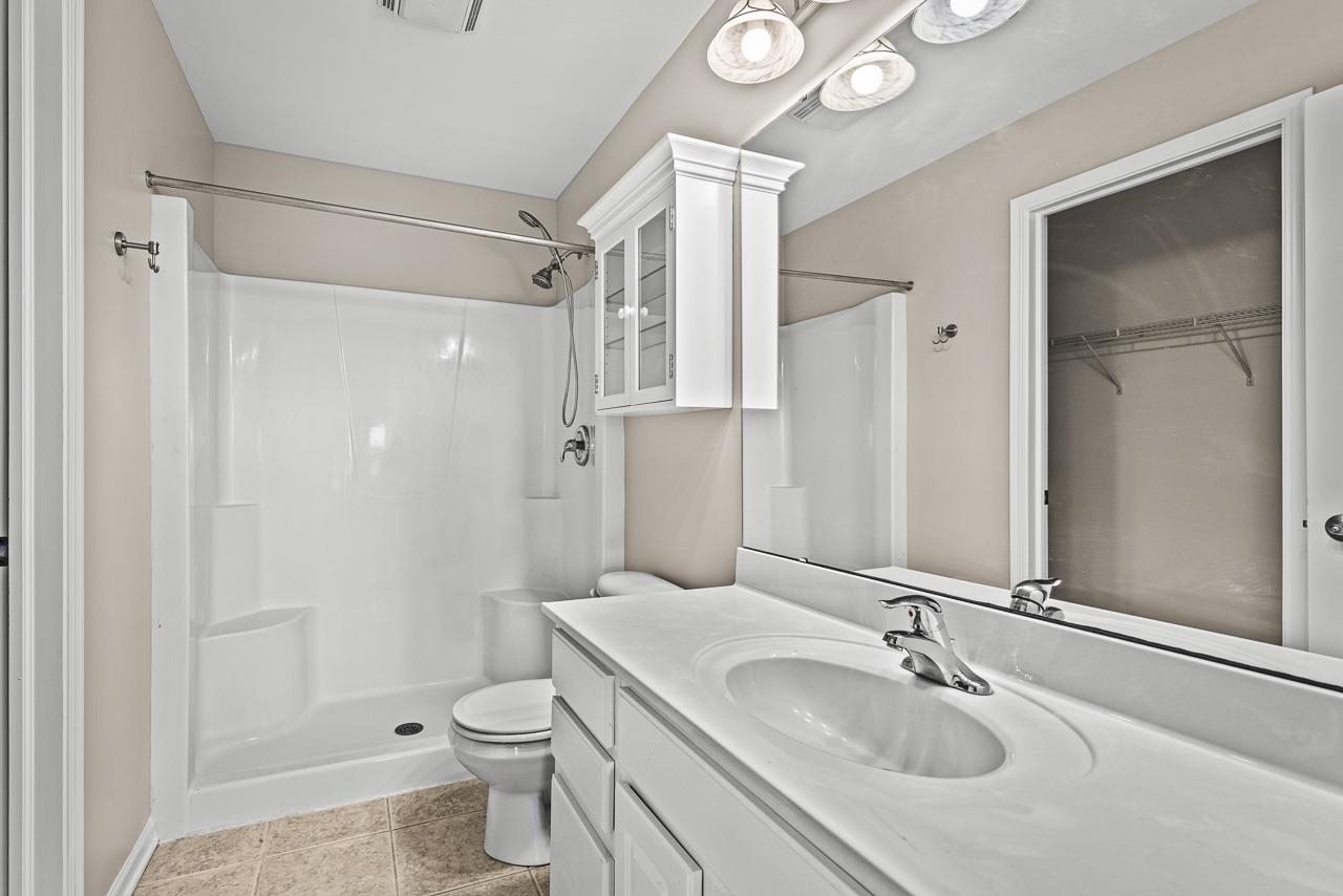 217 Market Street Genoa, IL 60135 - Photo 17 of 32 a bathroom with a sink a toilet and shower