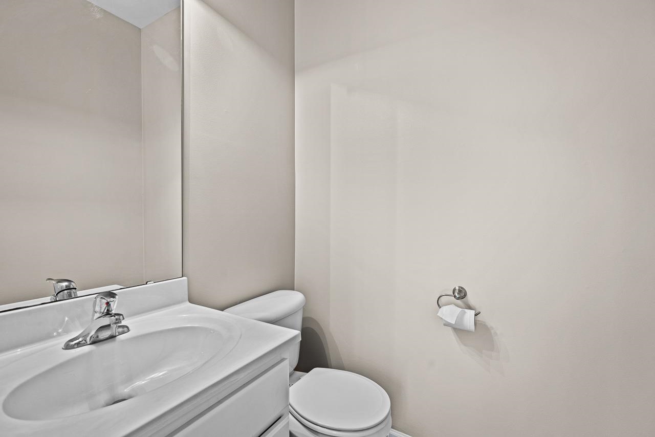 217 Market Street Genoa, IL 60135 - Photo 6 of 32 a white toilet sitting next to a bathroom sink
