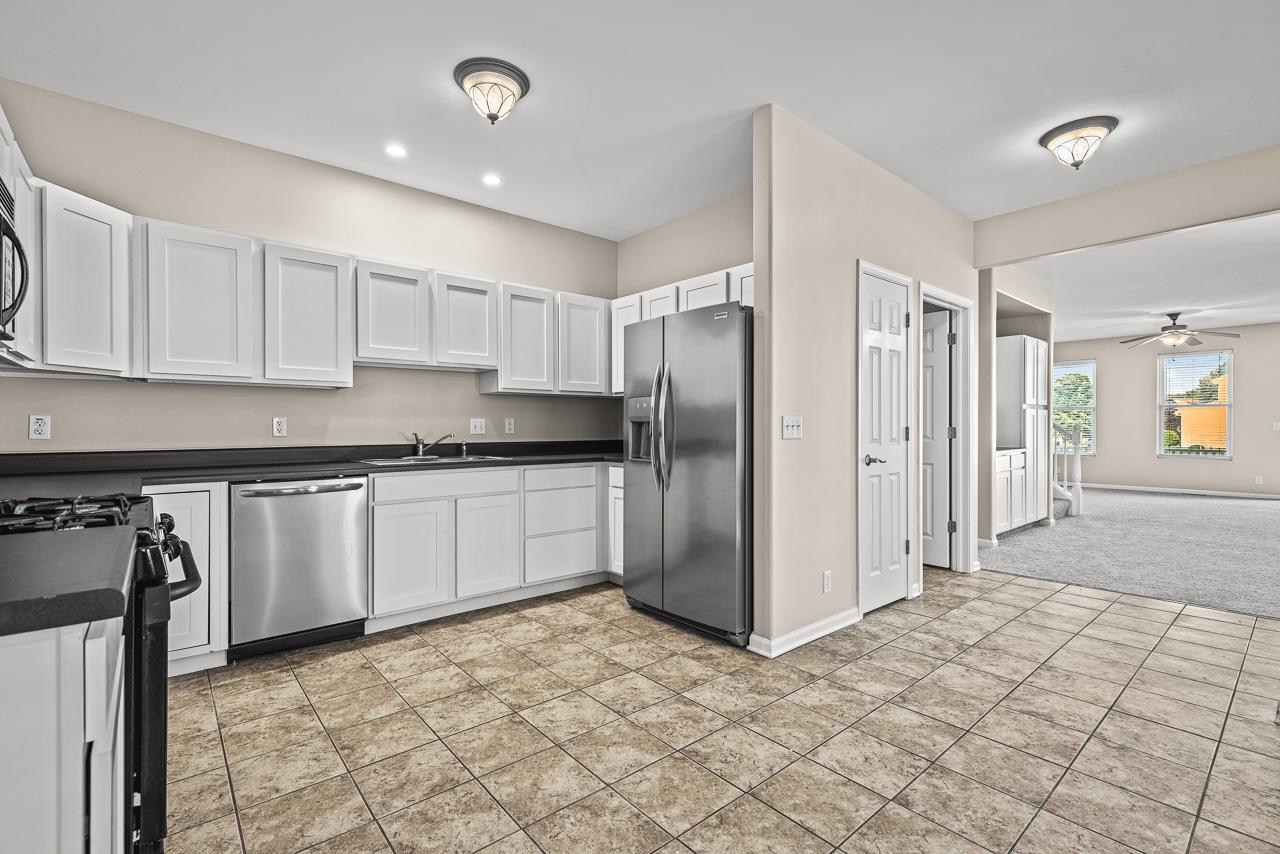 217 Market Street Genoa, IL 60135 - Photo 9 of 32 a kitchen with stainless steel appliances granite countertop a refrigerator and a stove top oven