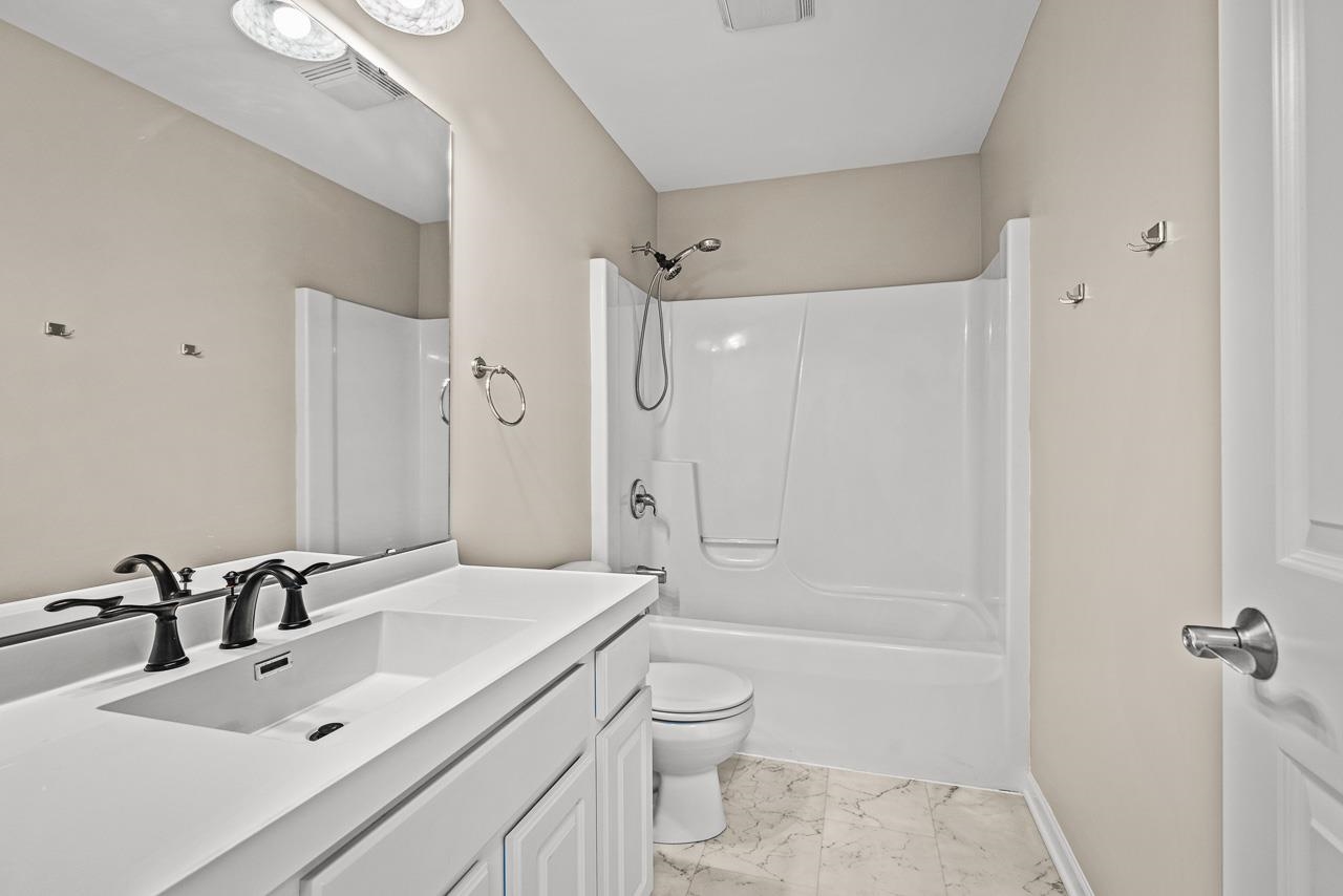 217 Market Street Genoa, IL 60135 - Photo 10 of 32 a bathroom with a sink a toilet and shower