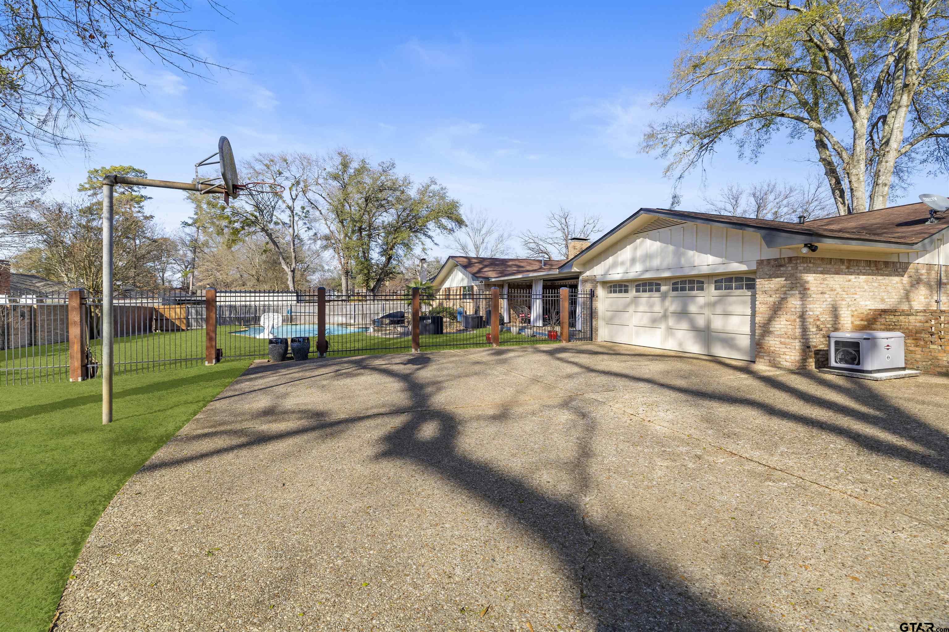 8235 Baylor Drive Tyler, TX 75703 - Photo 29 of 31 a view of a house with a yard
