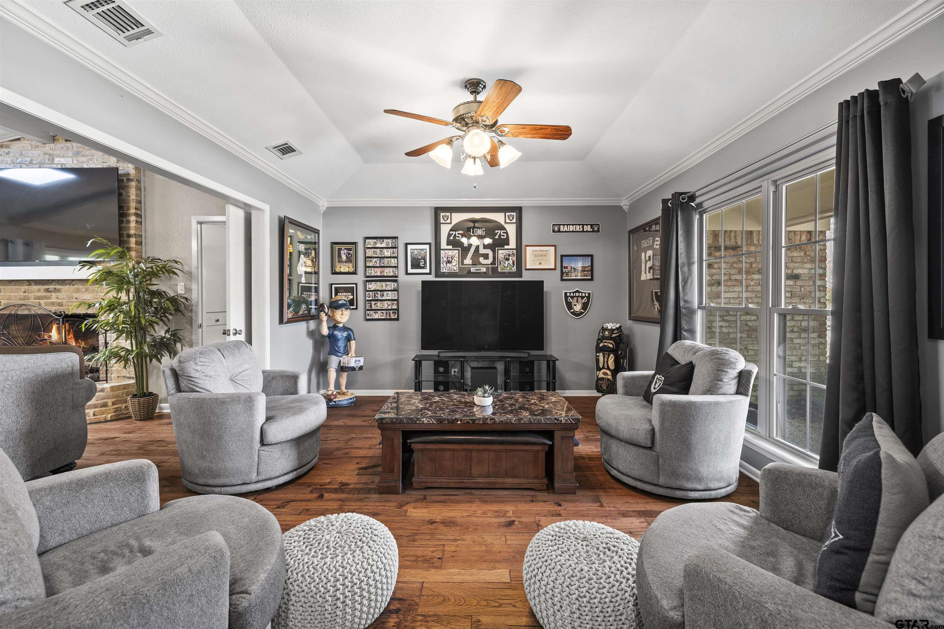 8235 Baylor Drive Tyler, TX 75703 - Photo 4 of 31 a living room with furniture a flat screen tv and a large window