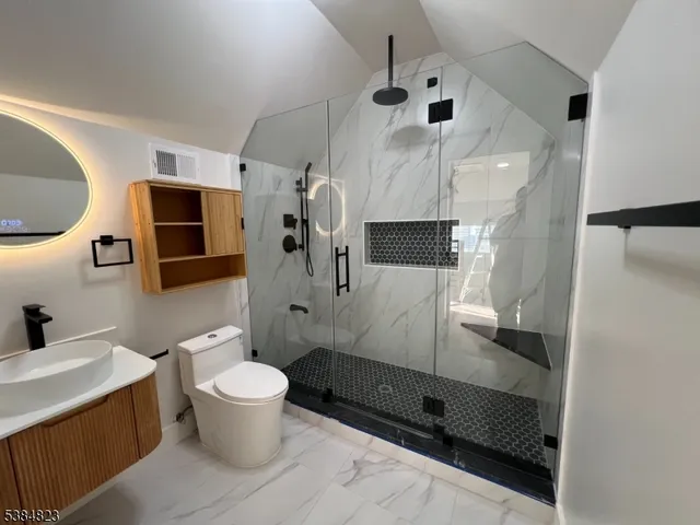 a bathroom with a sink toilet and shower