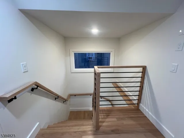 a view of room with stairs and wooden floor
