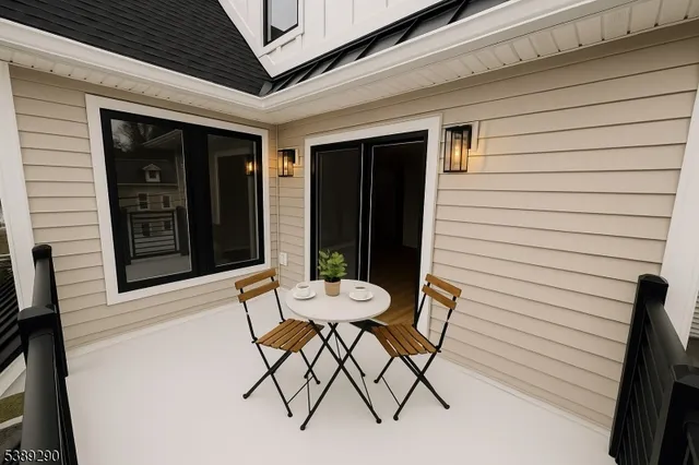 a view of a chair and table in front of the house