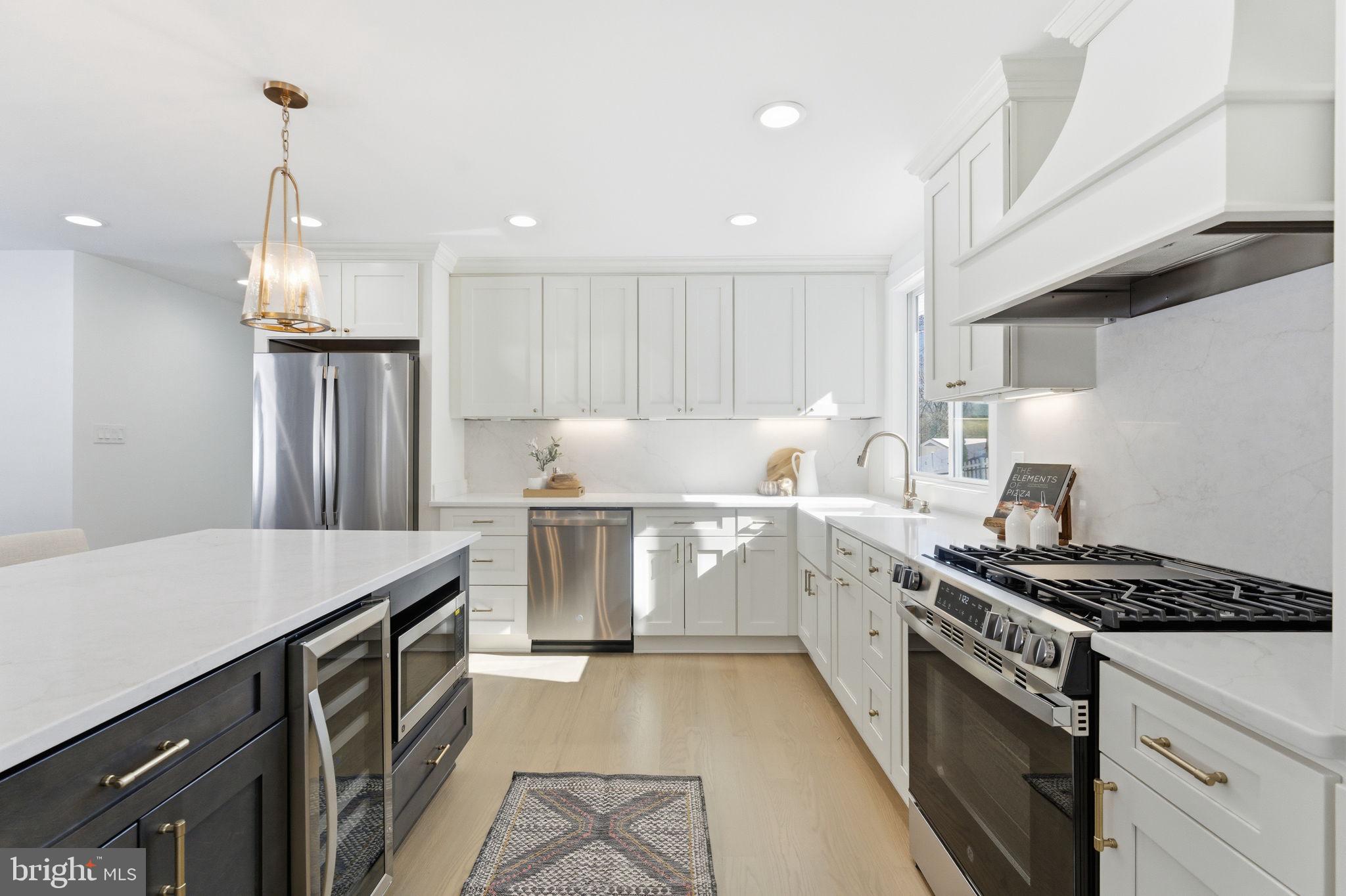 8615 Kerry Lane Springfield, VA 22152 - Photo 9 of 50 a kitchen that has a sink stainless steel appliances a counter space and a window