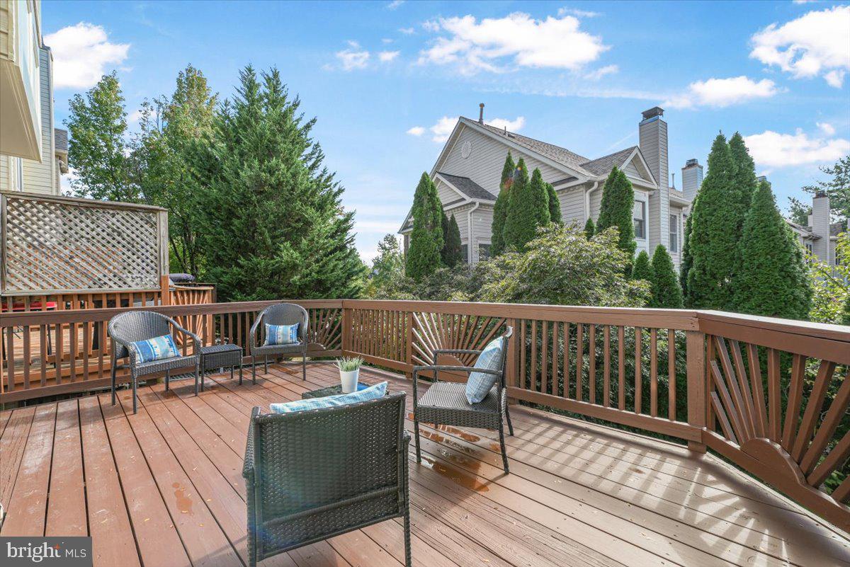12664 Granite Ridge Drive North Potomac, MD 20878 - Photo 13 of 37 a view of a deck with two chairs and wooden floor