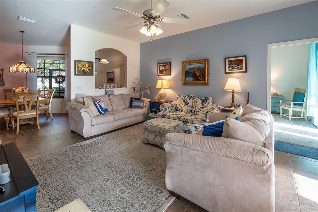 15969 Southwest 14th Avenue Road Ocala, FL 34473 - Photo 4 of 46 a living room with furniture and a chandelier