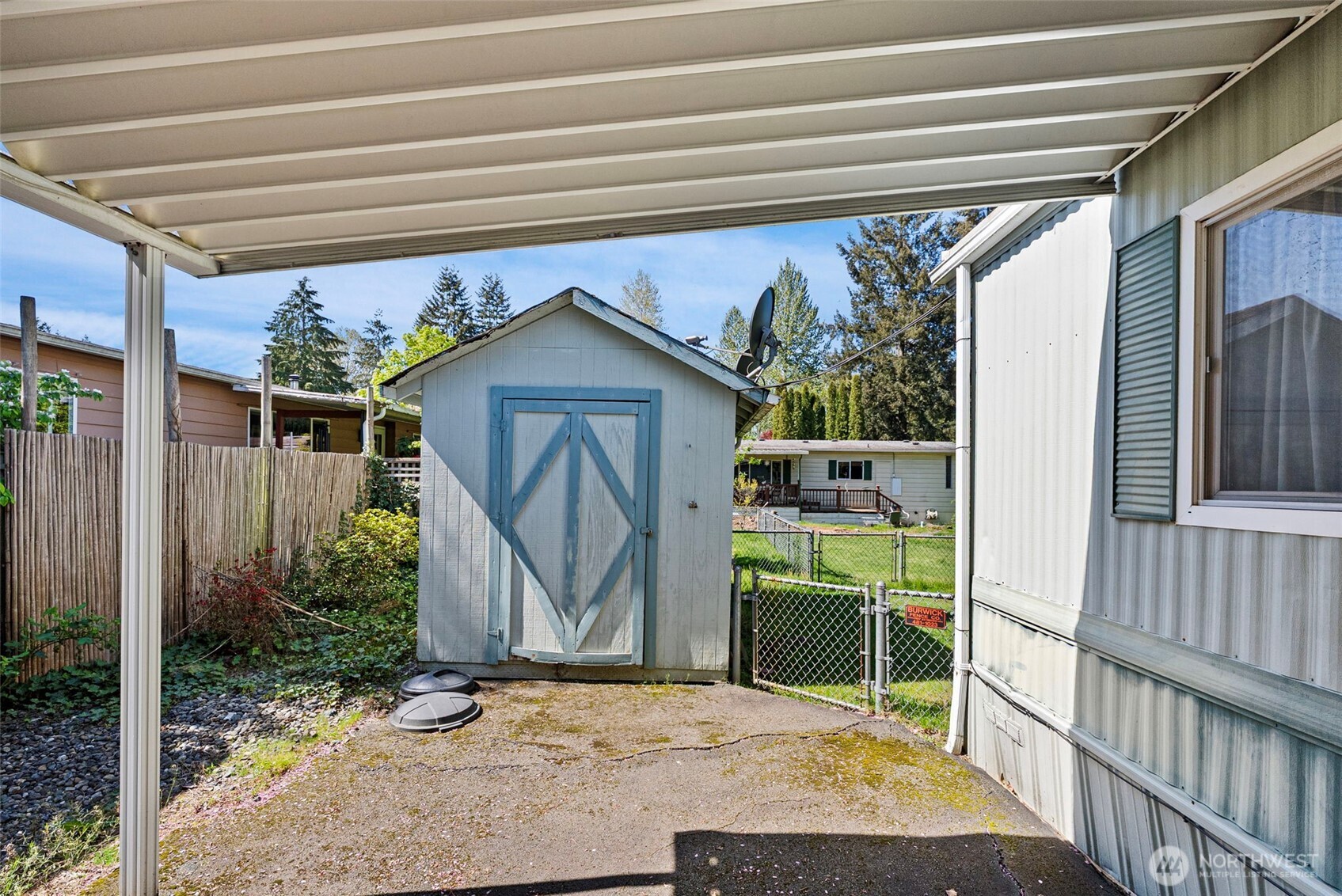 2200 196th Street Southeast, Unit 43 Bothell, WA 98012 - Photo 17 of 31 a wooden bench sitting in front of a house