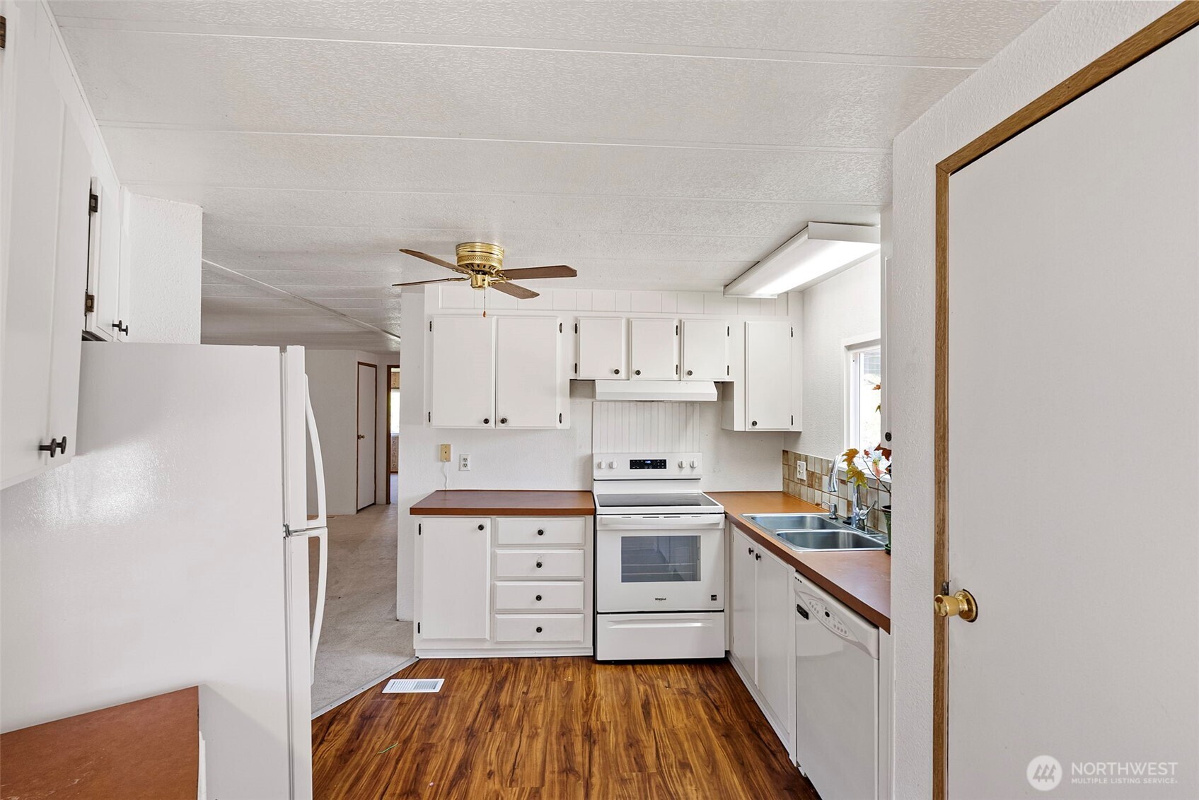 2200 196th Street Southeast, Unit 43 Bothell, WA 98012 - Photo 6 of 31 a kitchen with stainless steel appliances a refrigerator sink and cabinets