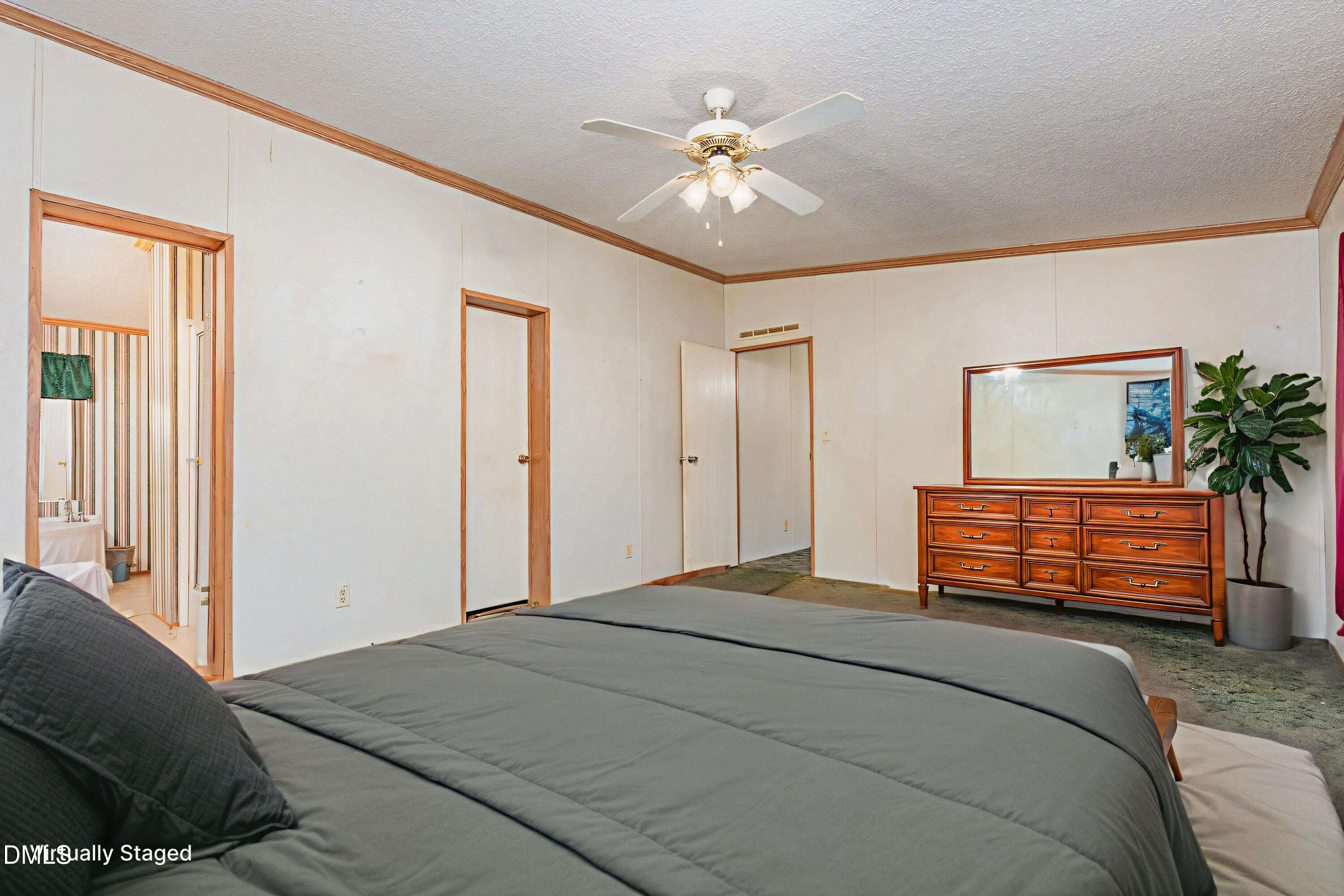 7472 Edwards Road Castalia, NC 27816 - Photo 14 of 36 a bedroom with a large bed and a chandelier