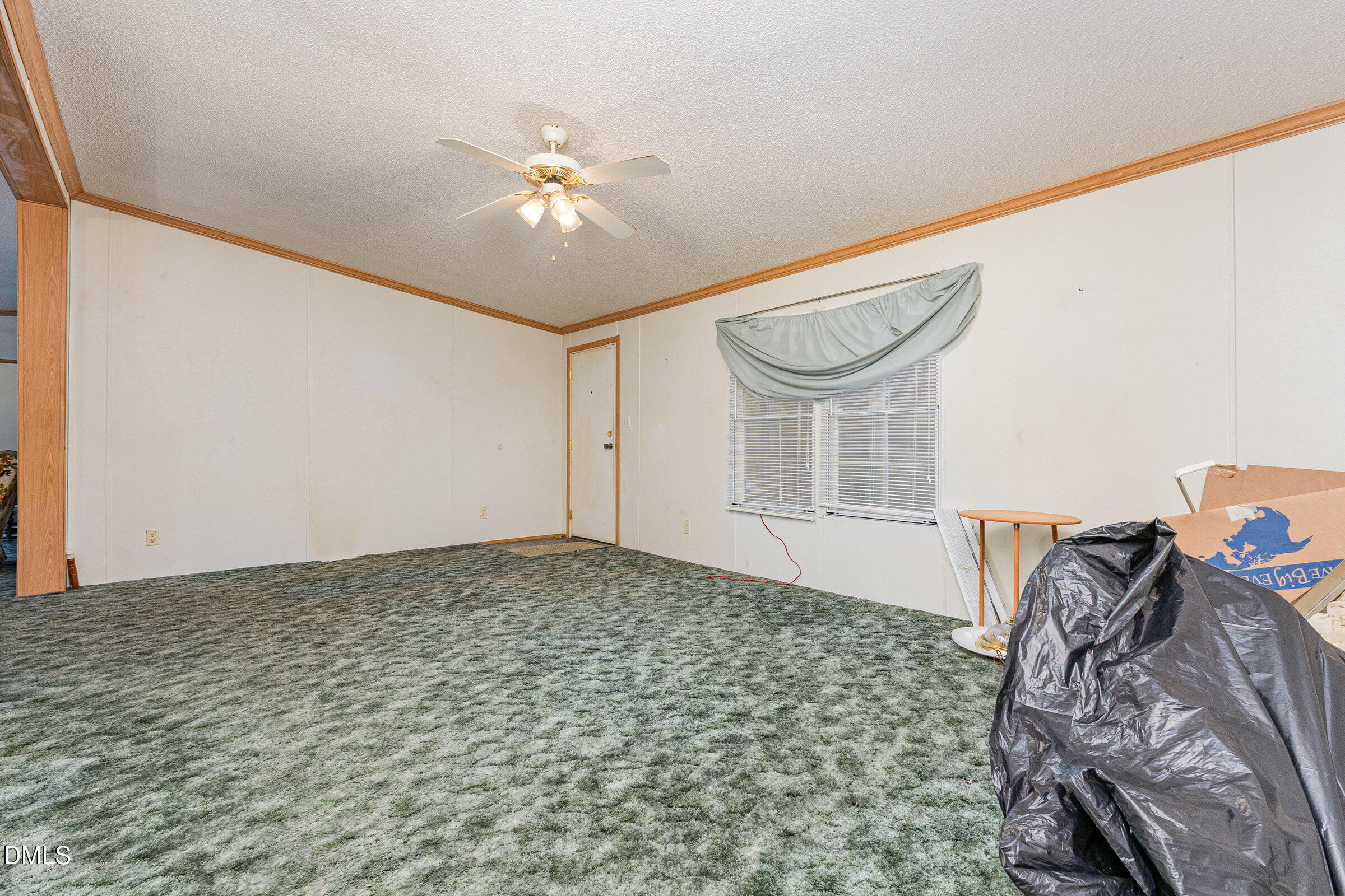 7472 Edwards Road Castalia, NC 27816 - Photo 17 of 36 a bedroom with a bed and a chandelier