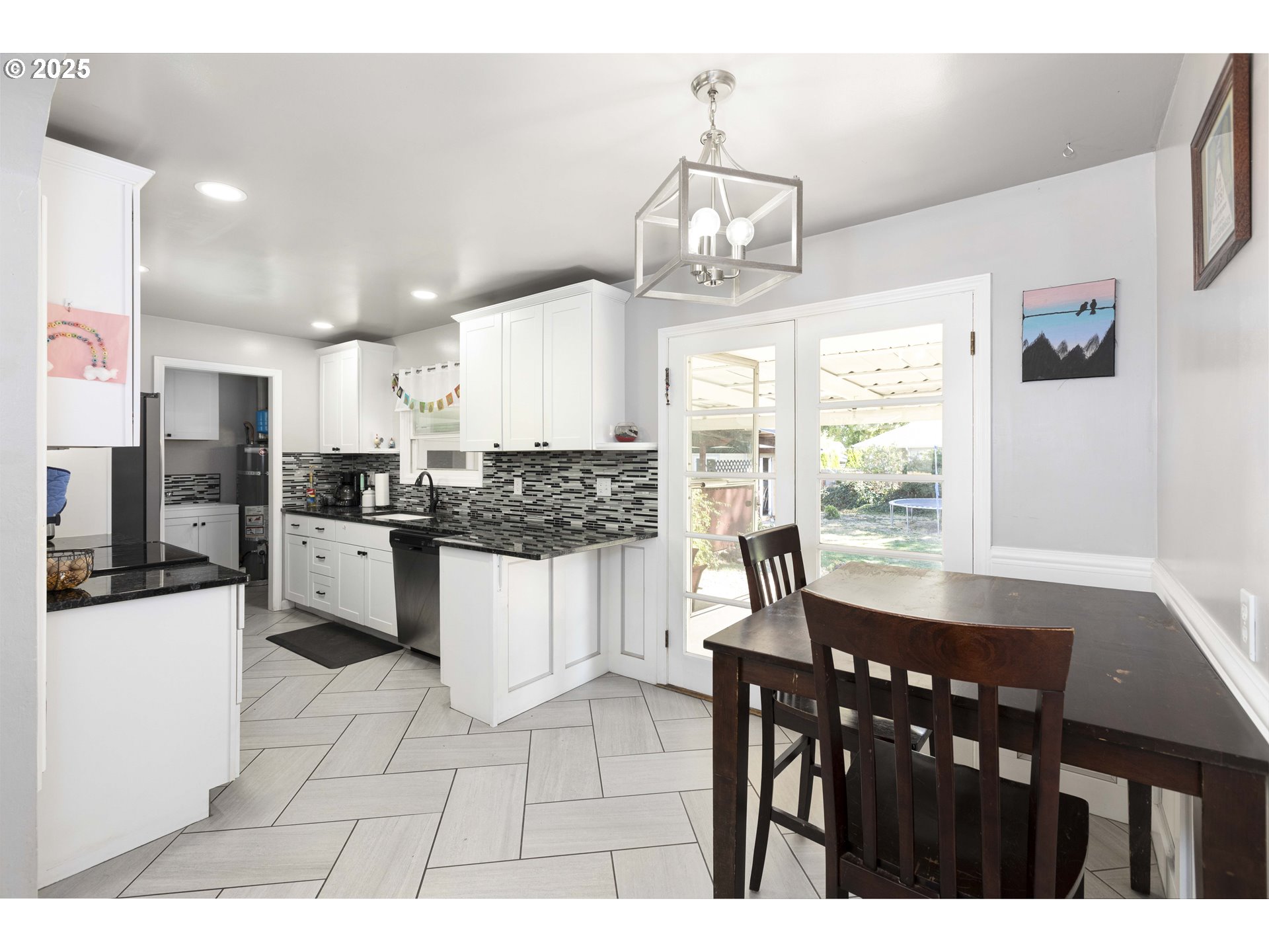 811 Northeast Clyde Place, Unit 116C Grants Pass, OR 97526 - Photo 18 of 37 a kitchen with stainless steel appliances kitchen island granite countertop a refrigerator a stove a sink dishwasher and white cabinets with wooden floor