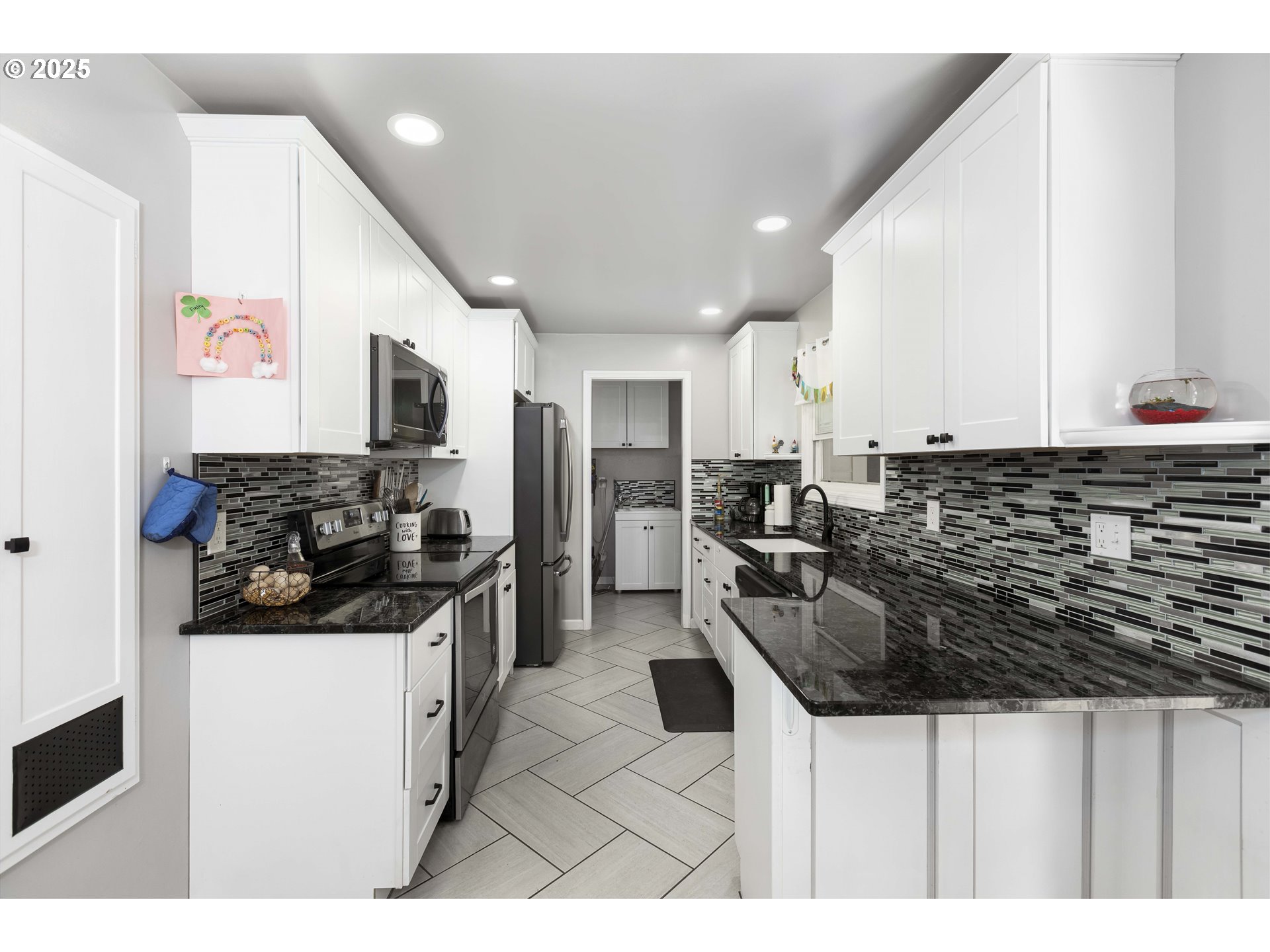 811 Northeast Clyde Place, Unit 116C Grants Pass, OR 97526 - Photo 22 of 37 a kitchen with stainless steel appliances kitchen island granite countertop a sink and cabinets