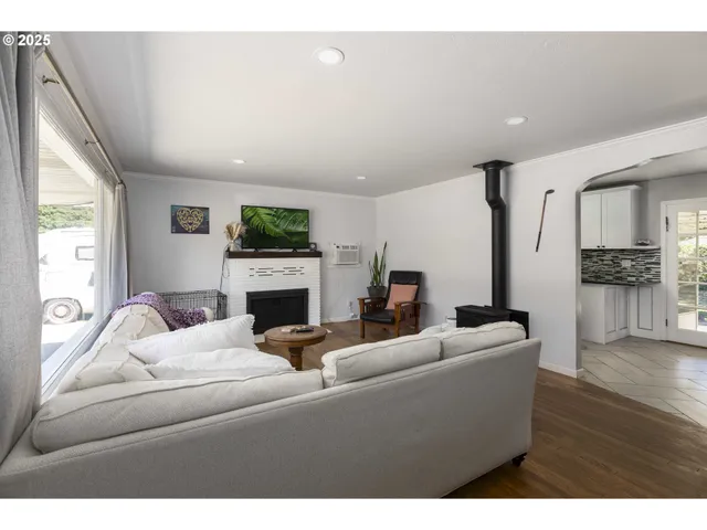 a living room with fireplace furniture and a wooden floor