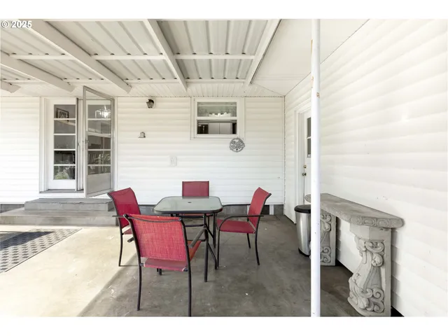 a view of a patio with table and chairs and potted plants