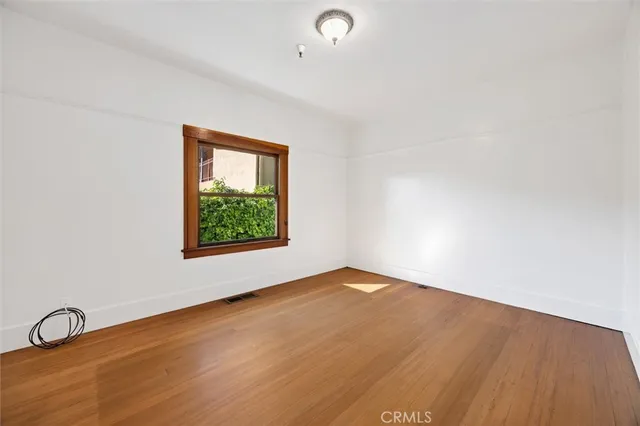 a living room with stainless steel appliances furniture a rug and a view of living room