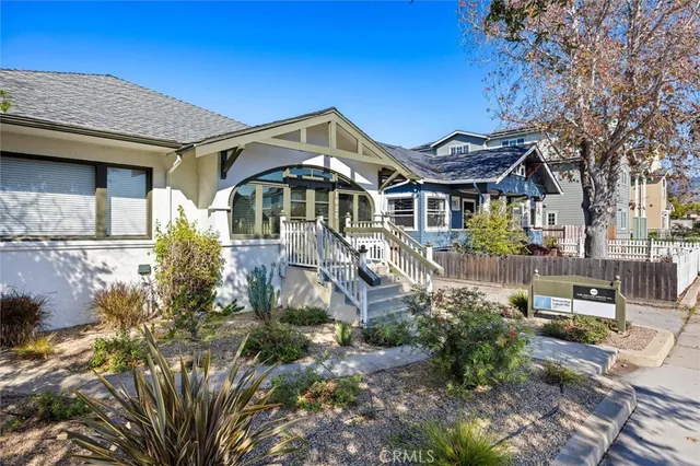 a dining room with furniture a fireplace and a chandelier