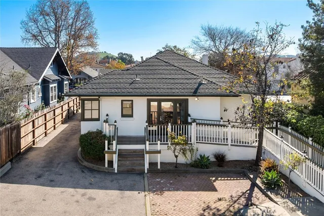 a front view of a house with garden