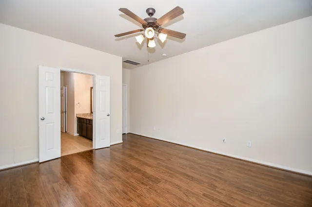 a view of an empty room with wooden floor
