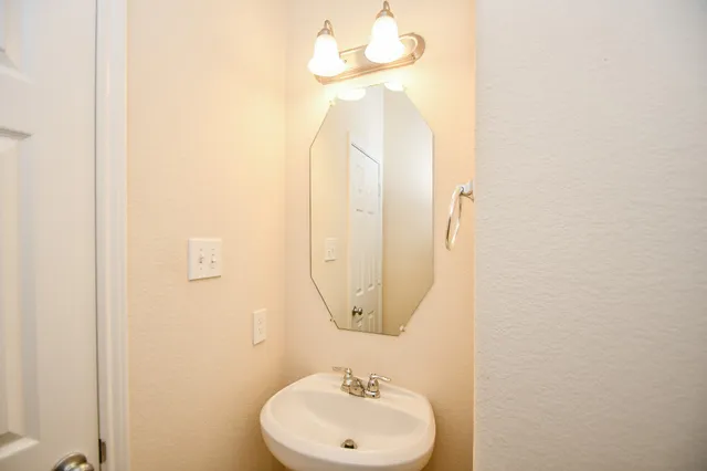 a view of a backyard with a garden and wooden fence