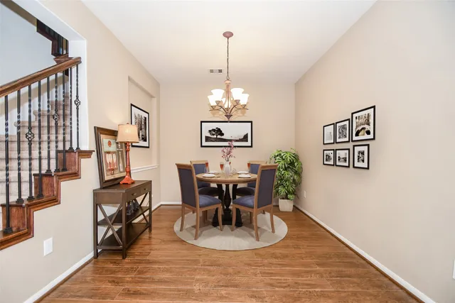 a view of a dining room with furniture and chandelier