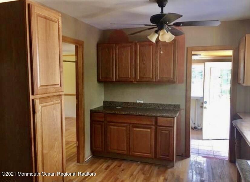 1144 Aldrich Road Jackson, NJ 08527 - Photo 11 of 24 a kitchen with stainless steel appliances granite countertop a stove a refrigerator and a cabinets with wooden floor