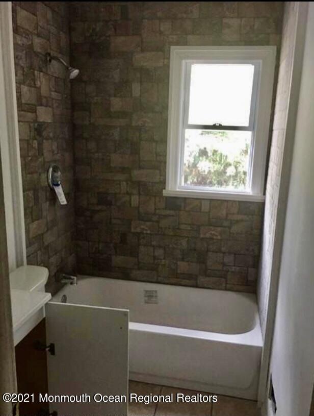 1144 Aldrich Road Jackson, NJ 08527 - Photo 12 of 24 a bath tub sitting next to a window