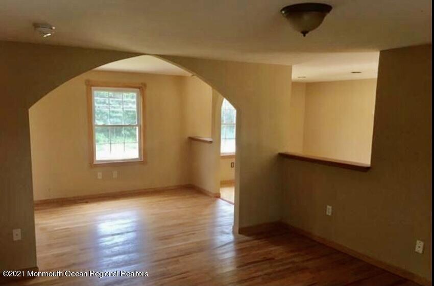1144 Aldrich Road Jackson, NJ 08527 - Photo 13 of 24 a view of an empty room with wooden floor and a window