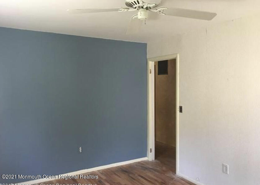 1144 Aldrich Road Jackson, NJ 08527 - Photo 14 of 24 an empty room with wooden floor and fan