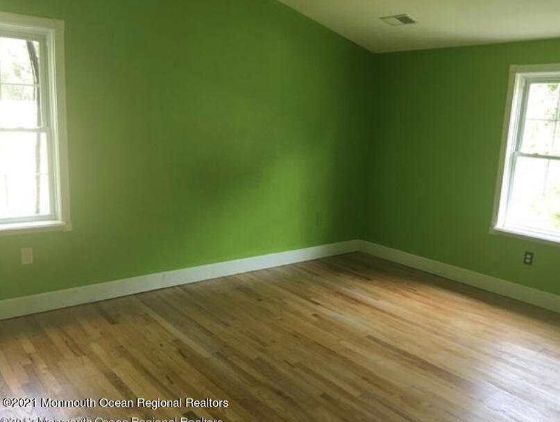 1144 Aldrich Road Jackson, NJ 08527 - Photo 17 of 24 a view of an empty room with wooden floor and a window