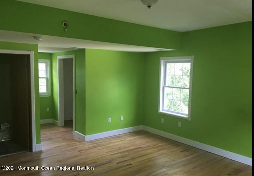 1144 Aldrich Road Jackson, NJ 08527 - Photo 18 of 24 a view of an empty room with a window and wooden floor