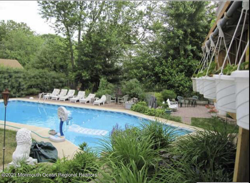 1144 Aldrich Road Jackson, NJ 08527 - Photo 4 of 24 a view of swimming pool with seating area and trees around
