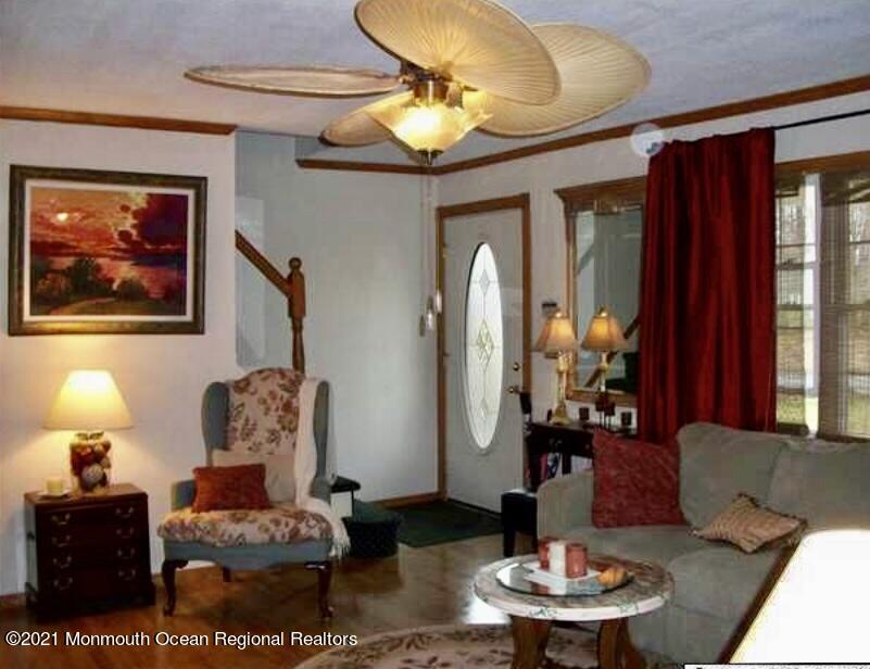 1144 Aldrich Road Jackson, NJ 08527 - Photo 6 of 24 a living room with furniture and a chandelier