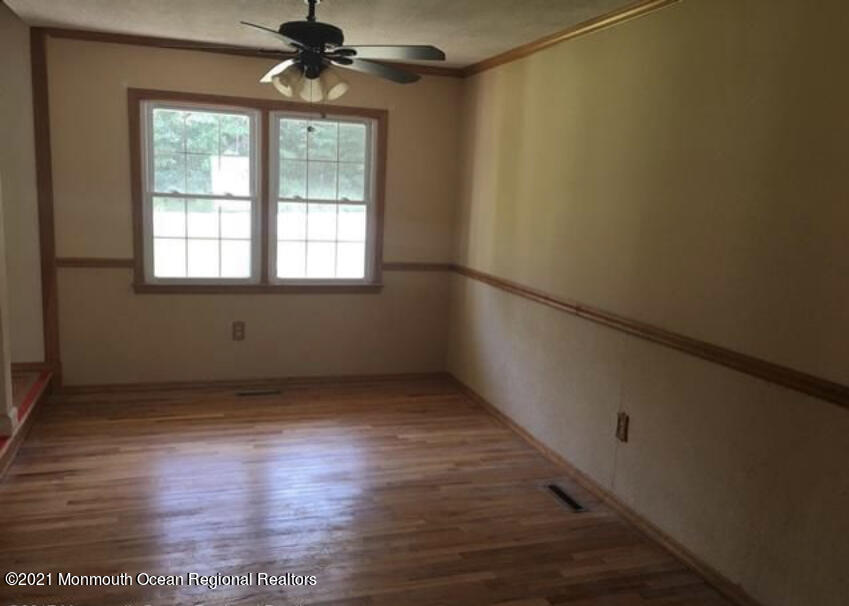 1144 Aldrich Road Jackson, NJ 08527 - Photo 7 of 24 a view of an empty room with a window and wooden floor