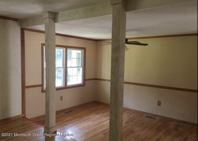 1144 Aldrich Road Jackson, NJ 08527 - Photo 9 of 24 a view of an empty room with wooden floor and a window