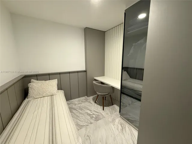 a bedroom with a bed and lamps