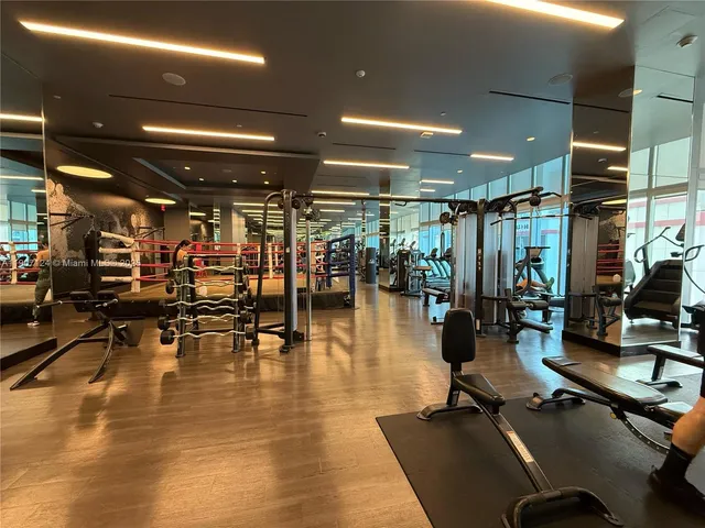 a gym room with lots of gym equipment