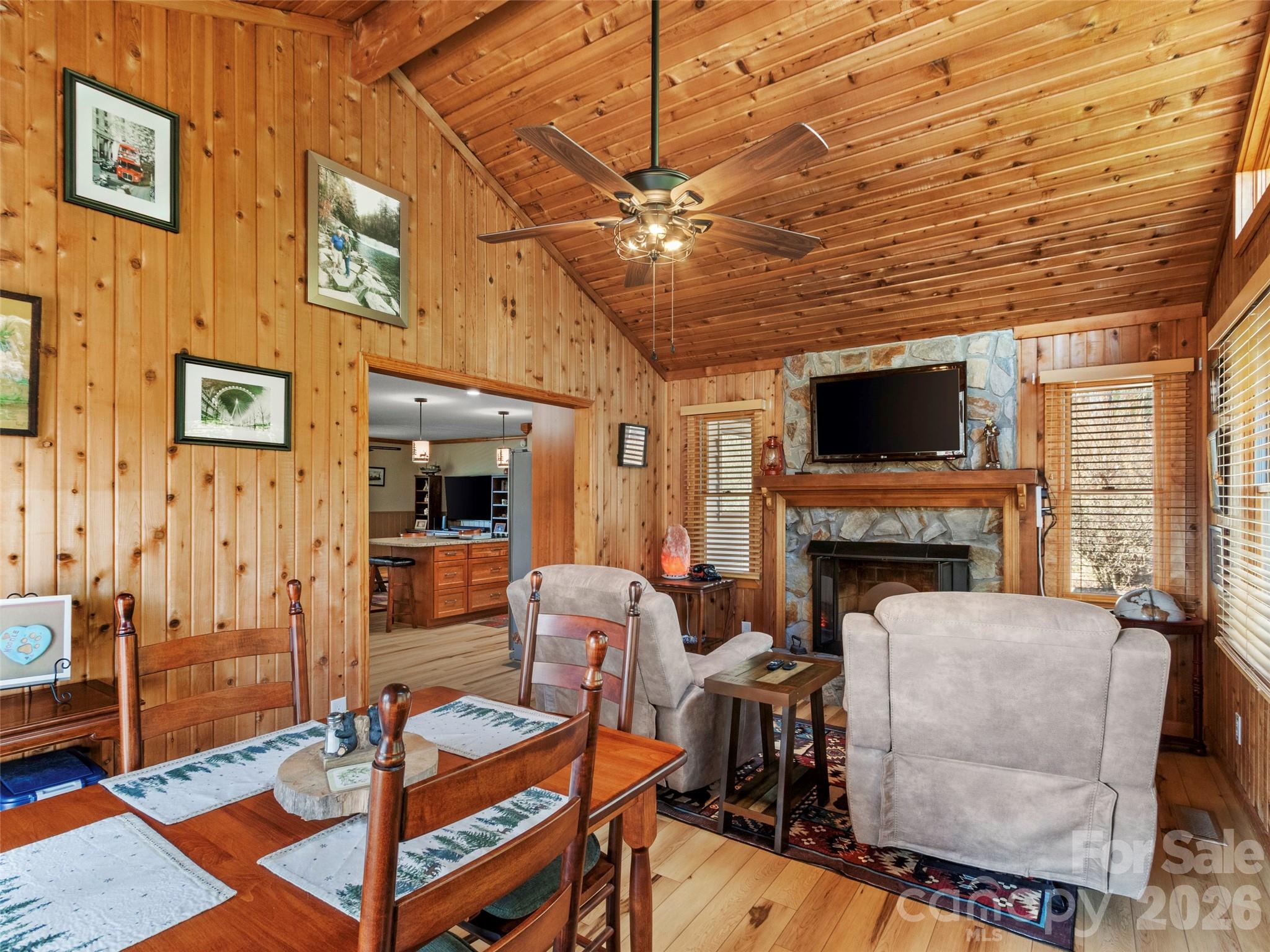 342 Mountain View Road Burnsville, NC 28714 - Photo 20 of 46 a living room with furniture a fireplace and a flat screen tv