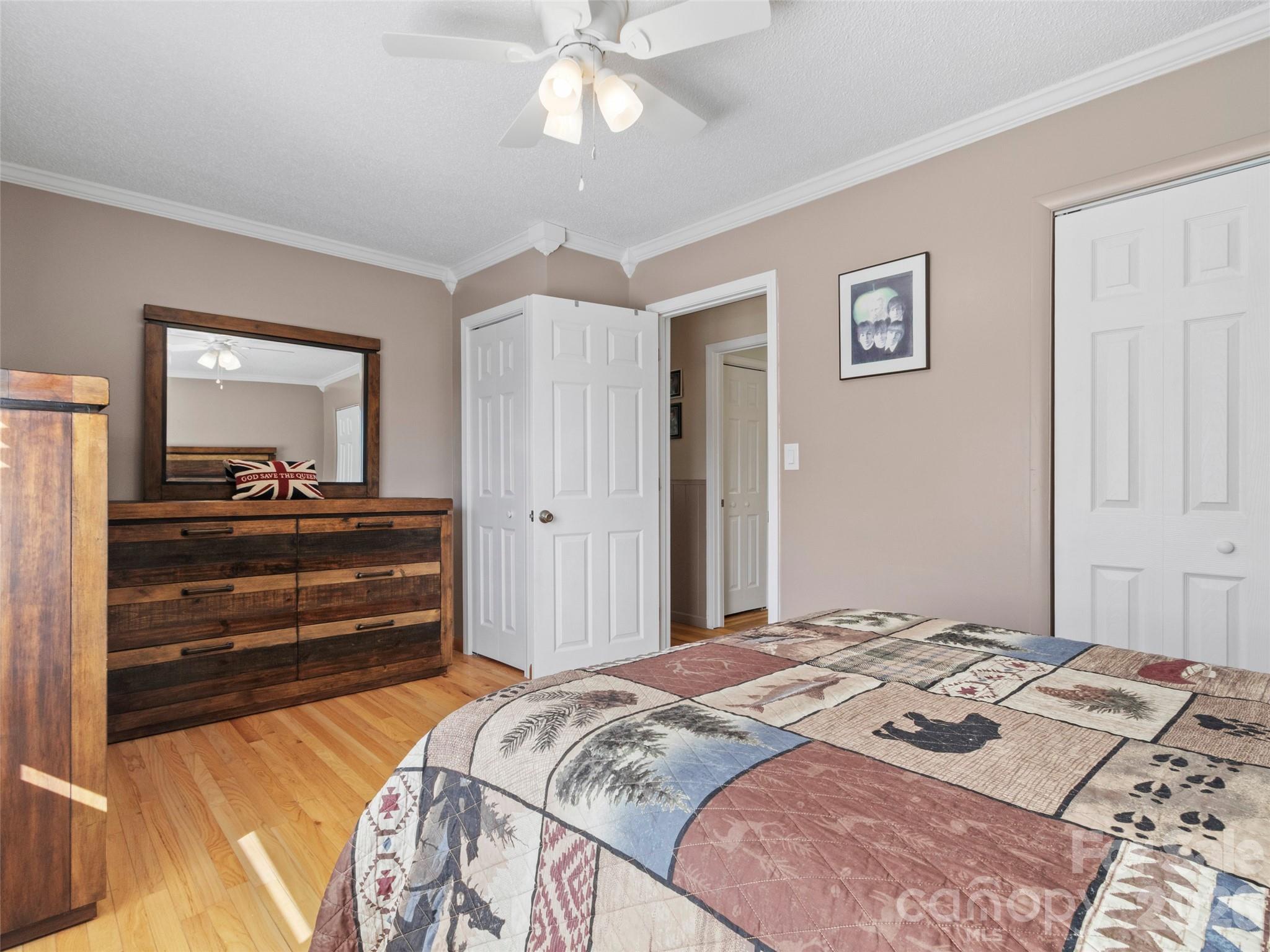 342 Mountain View Road Burnsville, NC 28714 - Photo 32 of 46 a bedroom with a bed and a chandelier