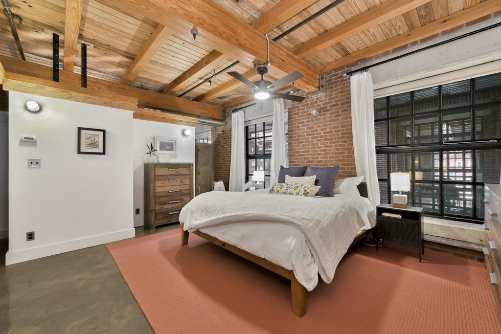 30 Howard Street, Unit 1 Somerville, MA 02144 - Photo 19 of 32 a spacious bedroom with a bed and a large window