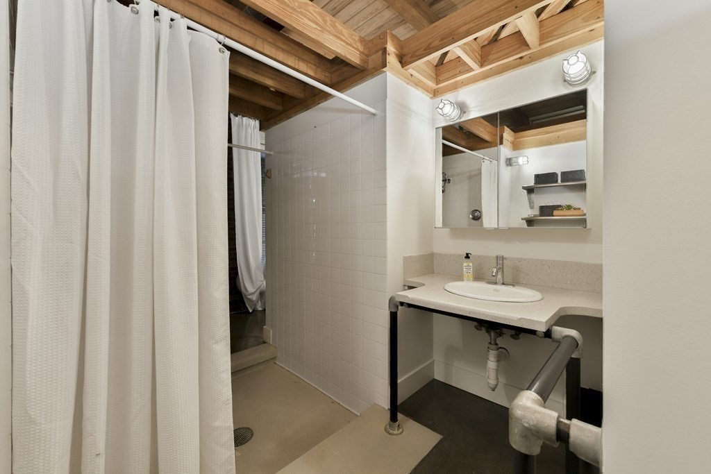 30 Howard Street, Unit 1 Somerville, MA 02144 - Photo 20 of 32 a bathroom with a sink and a mirror