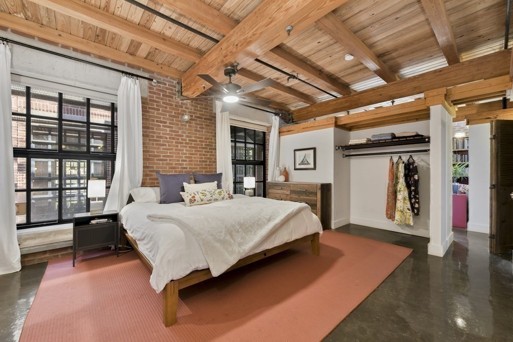 30 Howard Street, Unit 1 Somerville, MA 02144 - Photo 22 of 32 a spacious bedroom with a bed and a large window