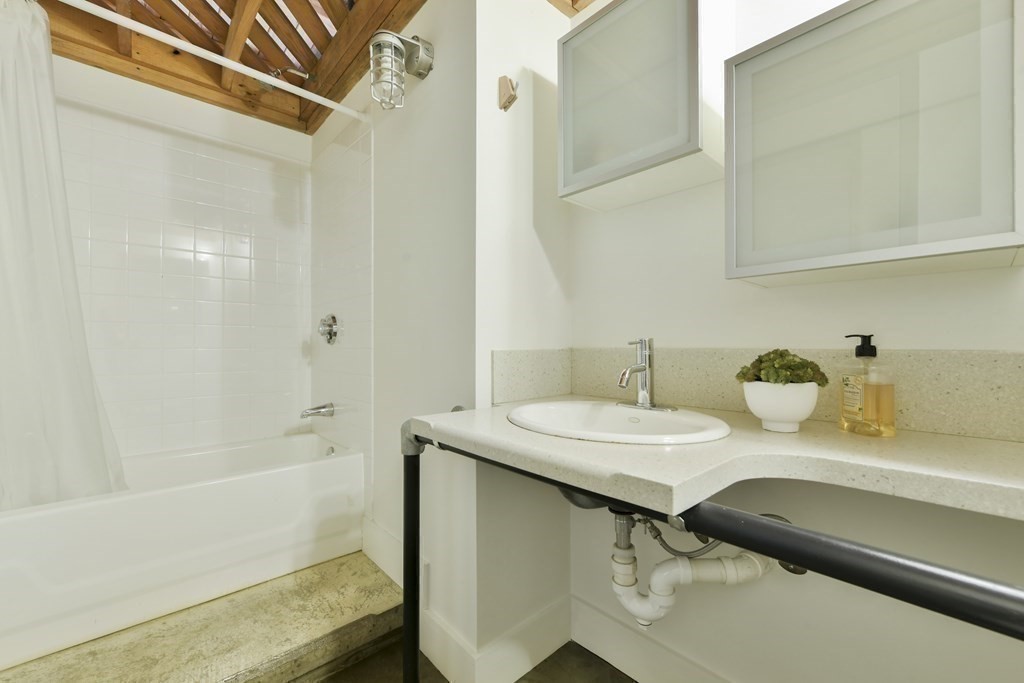 30 Howard Street, Unit 1 Somerville, MA 02144 - Photo 25 of 32 a bathroom with a sink and a mirror