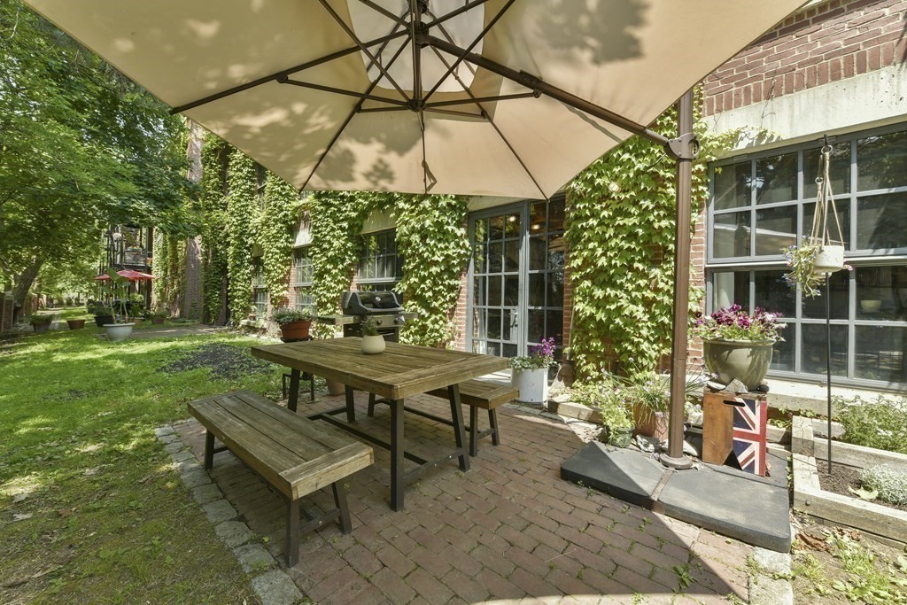 30 Howard Street, Unit 1 Somerville, MA 02144 - Photo 27 of 32 a view of a backyard with sitting area and furniture