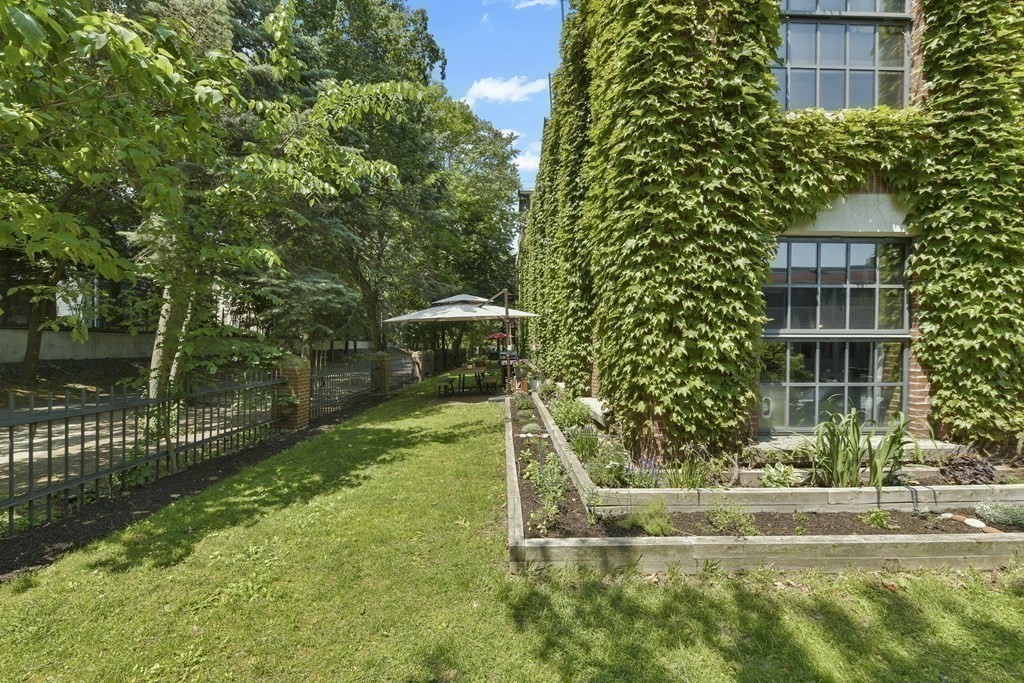 30 Howard Street, Unit 1 Somerville, MA 02144 - Photo 30 of 32 a view of a house with a yard