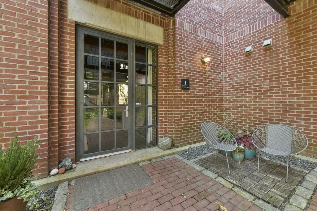 30 Howard Street, Unit 1 Somerville, MA 02144 - Photo 4 of 32 a blue chair sitting in front of a building