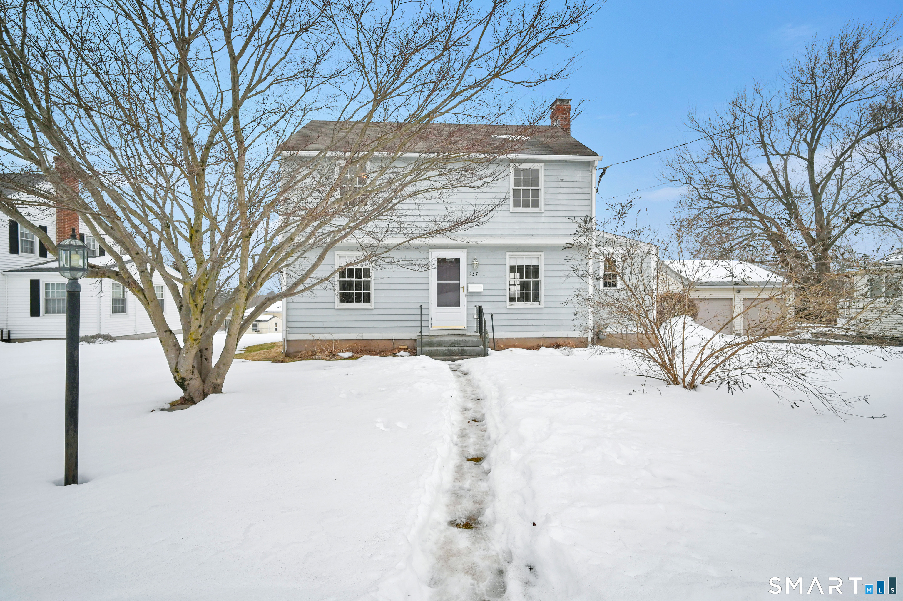 37 Dobson Circle Middletown, CT 06457 - Photo 1 of 1 a front view of a house with a yard covered in snow