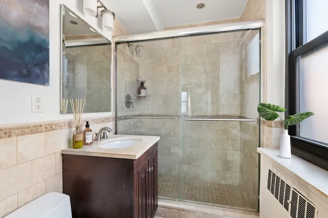 a bathroom with a sink toilet and shower