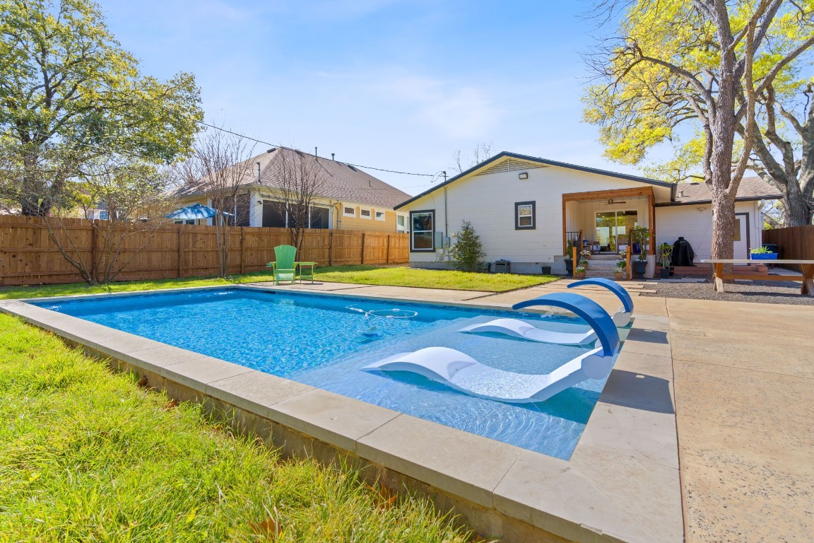 a house with swimming pool in front of it